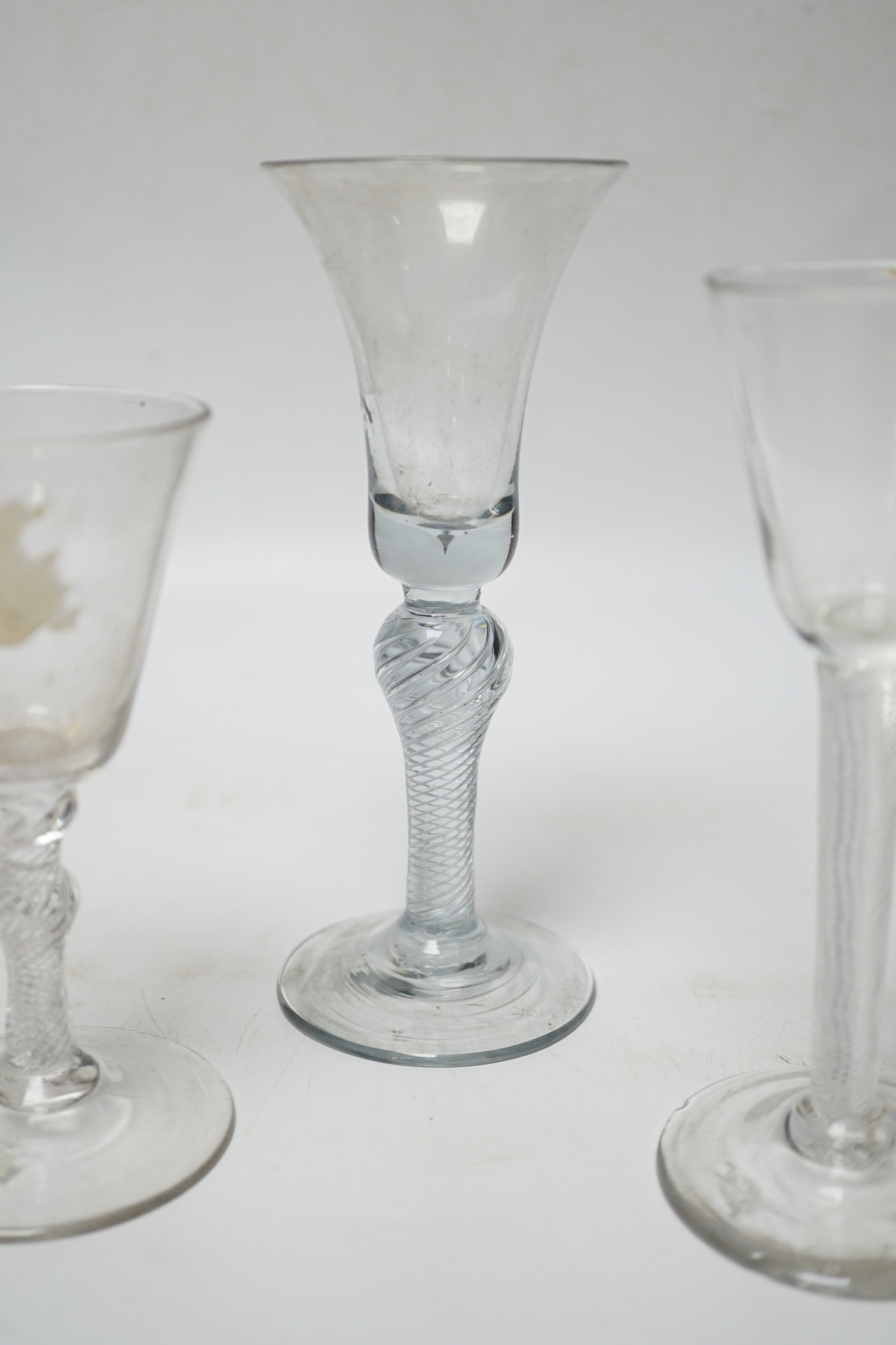 Three 18th century air twist stemmed wine glasses, tallest 16.5cm high